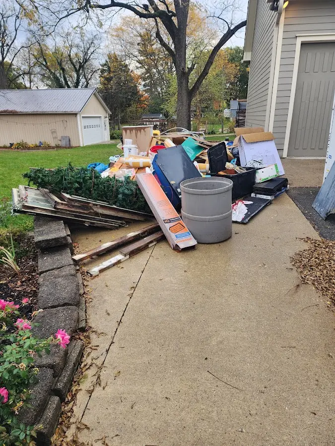 Dumpster being loaded with debris for 12 Yard Dumpster Rental in Florence